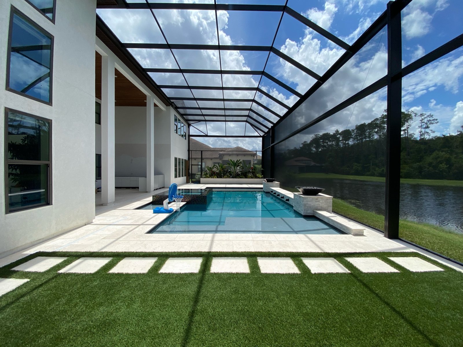Pool screen enclosure installation in Palm Bay, FL covering modern residential pool patio